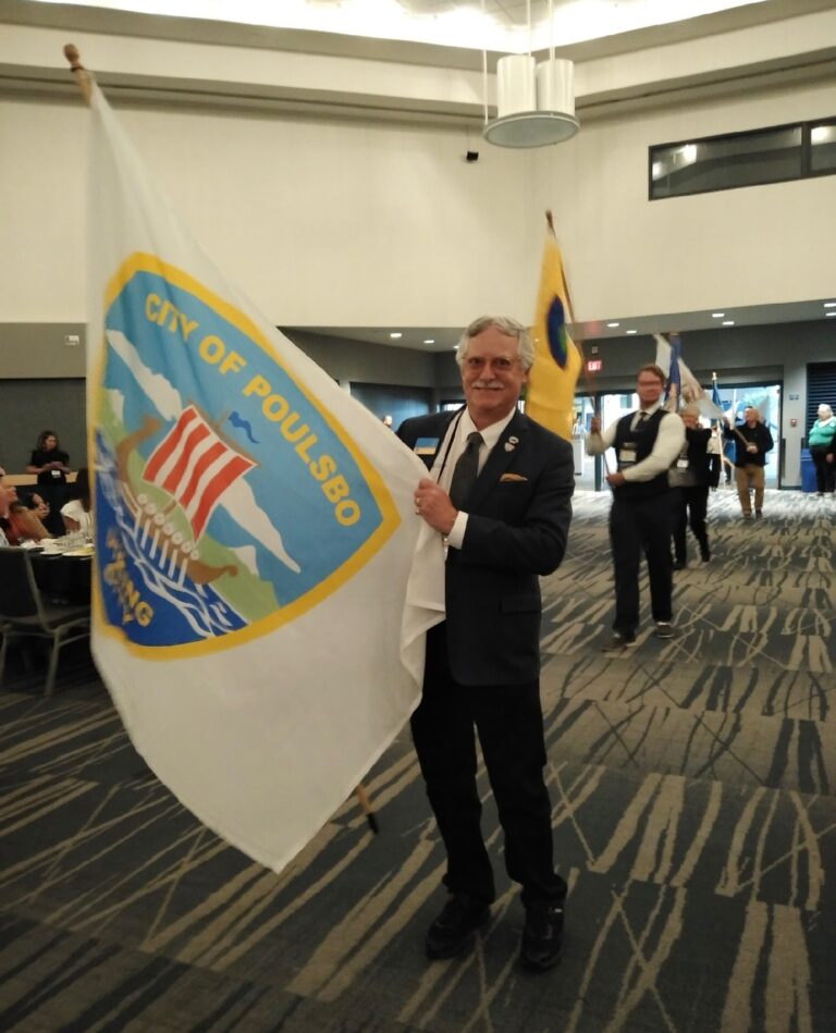 Carrying Poulsbo’s city flag with pride at the annual Association of Washington Cities (AWC) general assembly, joining 280 other cities in the procession.