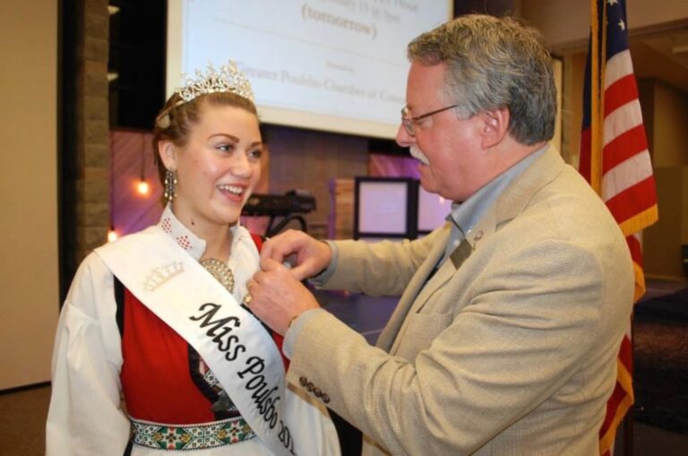 Carrying on a nearly 20-year tradition of representing the City at Poulsbo Chamber of Commerce luncheons, pinning each newly crowned Miss Poulsbo with the official city lapel pin on her authentic Norwegian ‘bunad’ dress.